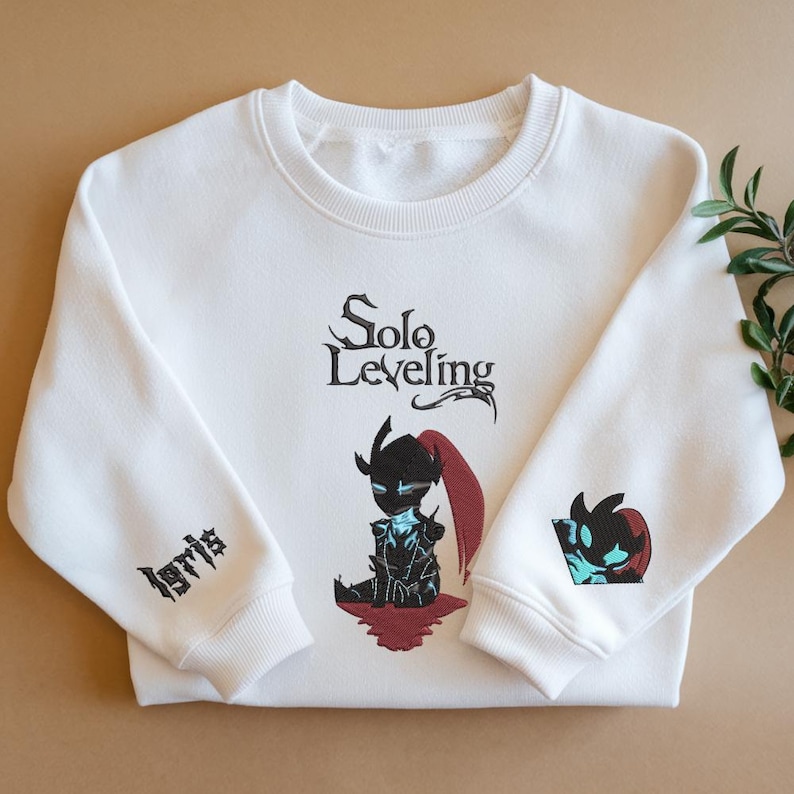 May include: White sweatshirt with a black and red illustration of a character from the Solo Leveling manga. The text "Solo Leveling" is printed in black above the character. The text "Igris" is embroidered on the left sleeve.