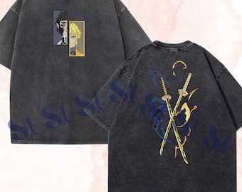 May include: A charcoal grey acid-wash t-shirt featuring a front graphic of two split character portraits in rectangular frames. The back displays a graphic of two crossed swords surrounded by blue and yellow flame-like patterns. Stitchales logo.