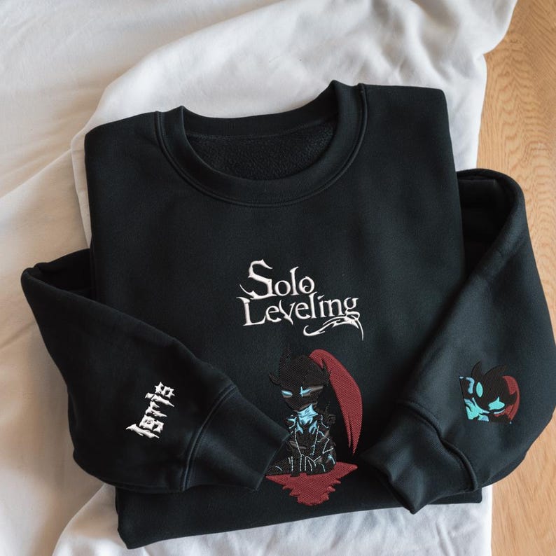 May include: Black sweatshirt with white embroidered text "Solo Leveling" and a black and red character illustration. The left sleeve has white embroidered text "Jeri's".