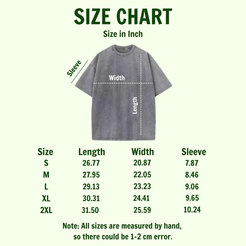 Puede incluir: Tabla de tallas para una camiseta gris, con medidas en pulgadas. La tabla incluye medidas de largo, ancho y manga para las tallas S, M, L, XL y 2XL. El texto indica que las tallas pueden variar en 1-2 cm.