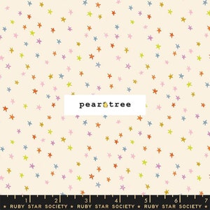 May include: A white fabric with a scattered pattern of colorful stars. The fabric has the text "pear tree" printed on it.