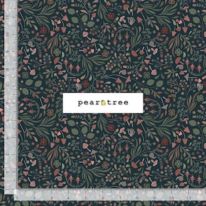 May include: A dark navy fabric featuring a repeating pattern of mushrooms, leaves, and small flowers in muted tones of pink, green, and brown. A white label with the text "pear tree" is centered. A ruler shows 11 inches along the side and bottom.