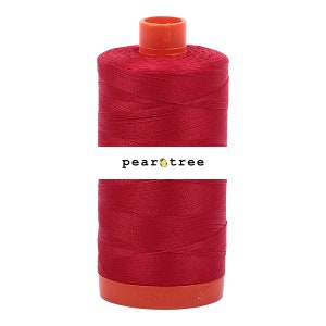 May include: A spool of red thread with a pear tree logo label. The thread is wound around a plastic spool with an orange top and bottom.
