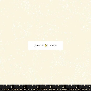 May include: A cream-colored fabric with a white speckled pattern. The fabric has a subtle texture and a pearlescent sheen. The text "pear tree" is printed in black on a white rectangle in the center of the fabric.