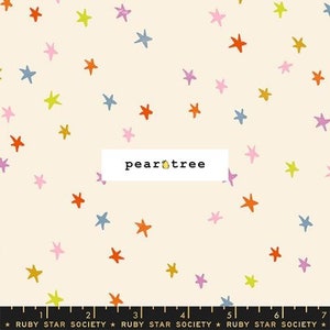 May include: Cream-colored fabric patterned with colorful stars in shades of orange, yellow, pink, purple, and blue. The text "pear tree" is in a white rectangle. The bottom of the fabric has a ruler with the text "RUBY STAR SOCIETY".