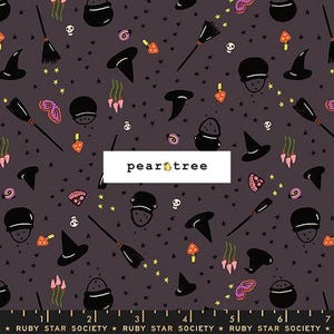 May include: A dark gray fabric featuring a repeating pattern of black witch hats, cauldrons, brooms, skulls, orange mushrooms, pink flowers, and yellow stars. The text "pear tree" is centered, and a ruler at the bottom shows 7 inches.