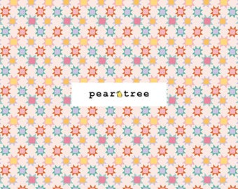 May include: A fabric with a repeating pattern of colorful starbursts in shades of pink, orange, yellow, blue, and green on a light pink background. The text "pear tree" is displayed in a white rectangle.
