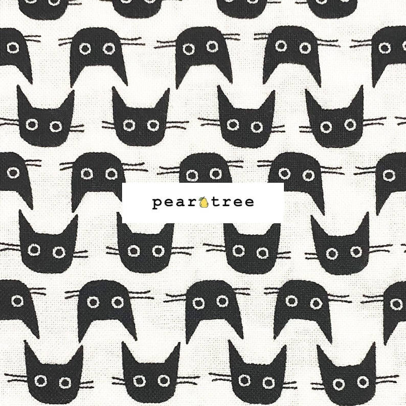May include: White fabric with a repeating pattern of black cat faces. The cat faces have two small circles for eyes and a curved line for a mouth.