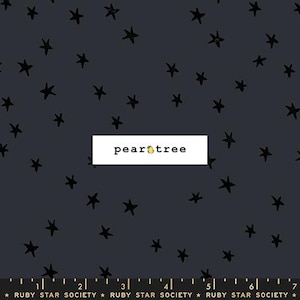 May include: Dark gray fabric with a scattered pattern of black stars. The fabric has a white rectangular label with the text "pear tree" and a small pear illustration. The bottom of the fabric has a ruler with the text "RUBY STAR SOCIETY".