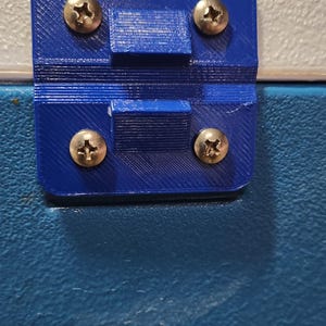 May include: A blue plastic hinge with four silver screws. The hinge is attached to a blue cooler.