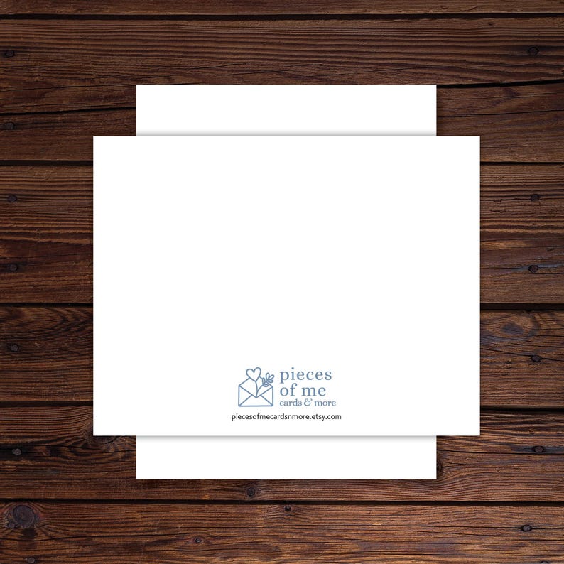 May include: A white greeting card with a matching envelope, set against a dark wood grain background. The card features the text "pieces of me cards & more" and the website address piecesofmecardsnmore.etsy.com.