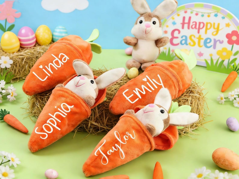 May include: Easter-themed plush toys featuring bunnies nestled in orange carrot-shaped containers, each with a name in white script. A standing bunny and decorative eggs are also present, set against a pastel backdrop with a "Happy Easter" sign.
