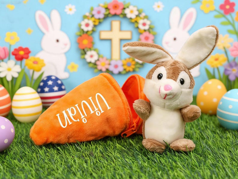 May include: An Easter-themed image featuring a plush bunny and an orange carrot-shaped bag with the name "Vivian" in white. Colorful Easter eggs and floral decorations are in the background, creating a festive scene.