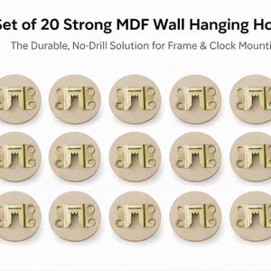 Puede incluir: Juego de 20 ganchos de pared de MDF. Cada gancho tiene una base beige circular con un soporte metálico dorado. El texto dice: "Set of 20 Strong MDF Wall Hanging Hooks. The Durable, No-Drill Solution for Frame & Clock Mounting."