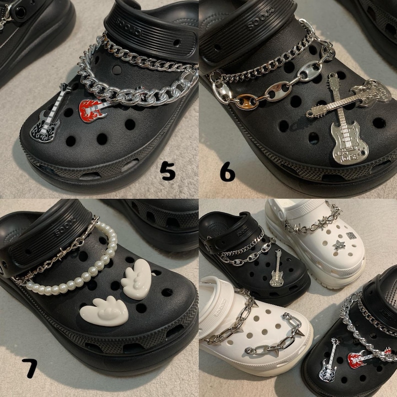 May include: Black clogs with decorative charms. One pair has a silver chain and guitar charm, another a silver chain and red guitar charm. Other pairs have pearl chains and charms.