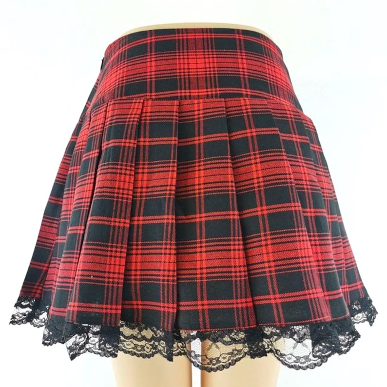 Women's Plaid Pleated Skirt | Contrast Vintage Y2k Clothes | Gothic Harajuku Fashion
.
Woman wearing a plaid pleated mini skirt styled with gothic accessories and layered outfit, showcasing Y2K Harajuku streetwear fashion.