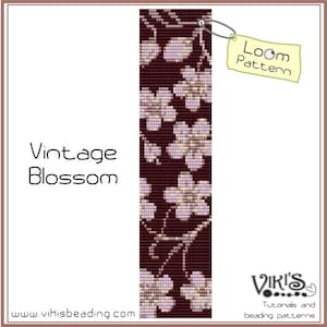 May include: A loom pattern titled "Vintage Blossom" featuring a floral design in shades of burgundy, cream, and lavender. The pattern includes the text "Loom Pattern" on a tag and the website address www.vikisbeading.com.