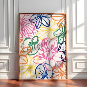 Puede incluir: Un cuadro enmarcado con un diseño floral abstracto. La obra presenta flores coloridas, estilo pincelada, en tonos rosa, azul, naranja, verde y amarillo sobre un fondo crema. El marco es de madera natural cálida.