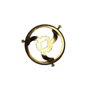 May include: A gold metal lampshade holder with three prongs. The holder is round and has a decorative design.