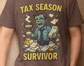 May include: Brown t-shirt with the text "TAX SEASON SURVIVOR" and a cartoon zombie holding coffee and tax forms. The zombie is surrounded by piles of paperwork. The shirt is worn by a person in white pants.