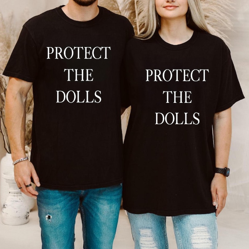 a man and a woman wearing matching t - shirts