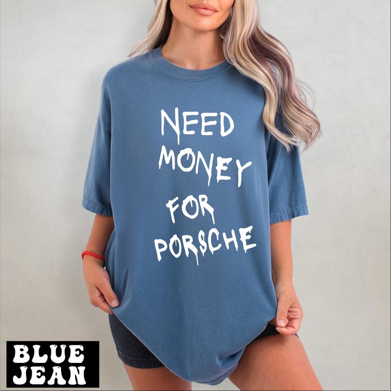 a blonde woman wearing a blue shirt that says need money for porsche