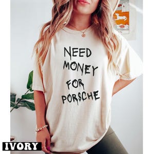 a woman wearing a t - shirt that says need money for porshe