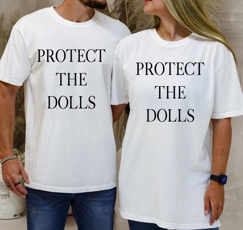 a man and woman wearing matching t - shirts that say protect the dolls
