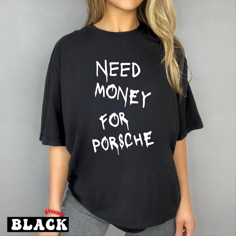 a woman wearing a black shirt that says need money for porsche