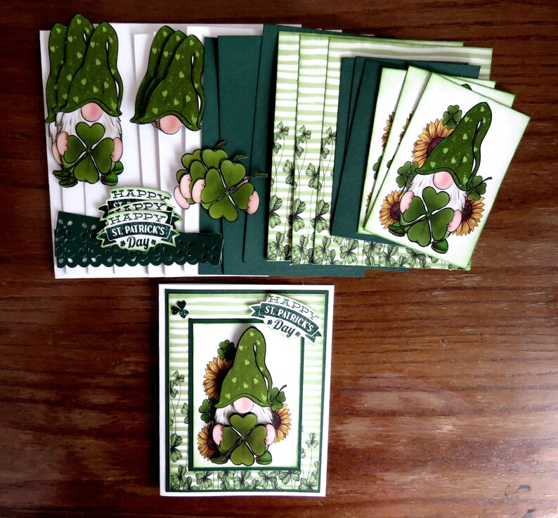 May include: St. Patrick's Day themed paper crafts. The image shows a collection of handmade cards, cutouts, and decorative elements. The designs feature gnomes, shamrocks, and sunflowers in green, white, and yellow. The phrase "Happy St. Patrick's Day" is also visible.