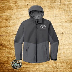 May include: A gray hooded jacket with a zipper closure and two pockets. The jacket has a white embroidered logo that says "Larsen Ranches FY Colorado".