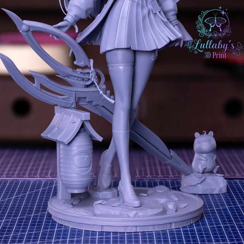 May include: A gray 3D-printed figurine of a character with a pleated skirt, holding a large weapon. The figurine includes a lantern, a small animal figure, and the text "Lullaby's 3D Print". The base is round and detailed.