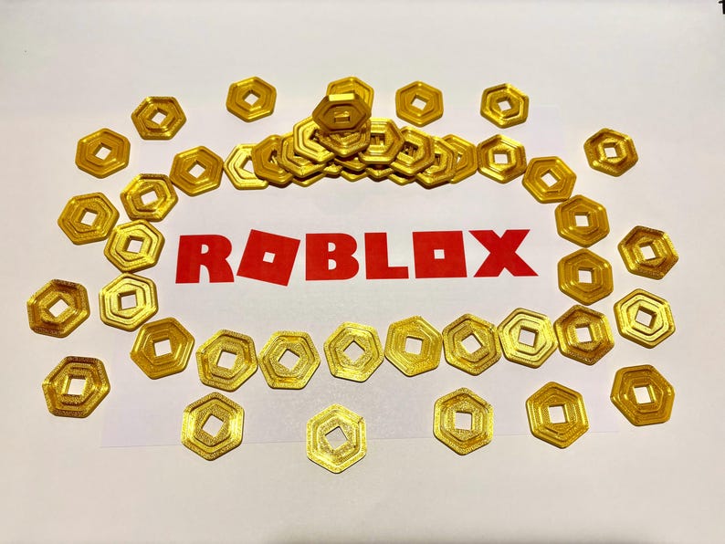May include: A collection of gold-colored Roblox game currency coins, with the word "ROBLOX" printed in red letters in the center of the image.