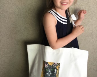 Large off white and black tote bag, picture of kitten on front (Adorable child not included)