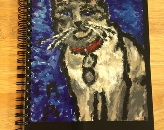 Black Spiral-bound notebook with a picture of a Beautiful Siamese Cat on the front, taken from an original artwork.