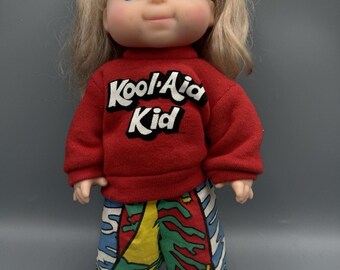 Bambola Kool-Aid Kid vintage del 1988, 30 cm, capelli biondi, maglietta rossa, Goldberger Eegee