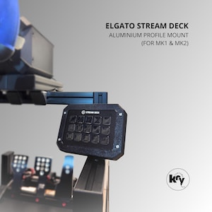 Könnte beinhalten: Ein schwarzes Elgato Stream Deck mit 15 beleuchteten Tasten, montiert auf einem Aluminiumprofil. Der Text "ELGATO STREAM DECK ALUMINIUM PROFILE MOUNT (FOR MK1 & MK2)" ist sichtbar. Für MK1- und MK2-Modelle.
