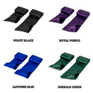 May include: Four satin ribbons in various colours: velvet black, royal purple, sapphire blue, and emerald green. Each ribbon is folded and labelled with its colour name underneath.