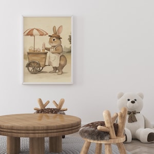 May include: A watercolor illustration of a brown rabbit wearing a straw hat and an apron, pushing a cart with ice cream cones. The rabbit is standing on a path with green grass and trees in the background.