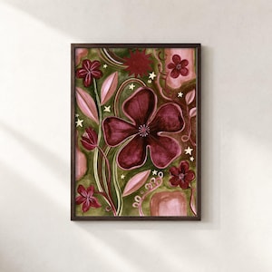 May include: A framed wall art print featuring a dark maroon flower as the central focus, surrounded by smaller maroon flowers, light pink leaves, and swirling stems against a deep olive green background with scattered small white stars.
