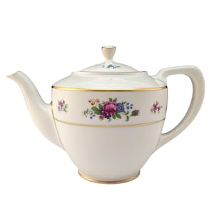 May include: White porcelain teapot with a lid, featuring a floral design in pink, purple, blue, and green. The teapot has a gold trim around the rim and base, and a curved handle. A small floral design is on the lid.