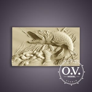 May include: A detailed relief carving of a pike fish with an open mouth, hook, and aquatic plants. The artwork is in a light beige color, with textured scales and fins. The image includes the text "O.V. MODEL STUDIO" in a circular logo.