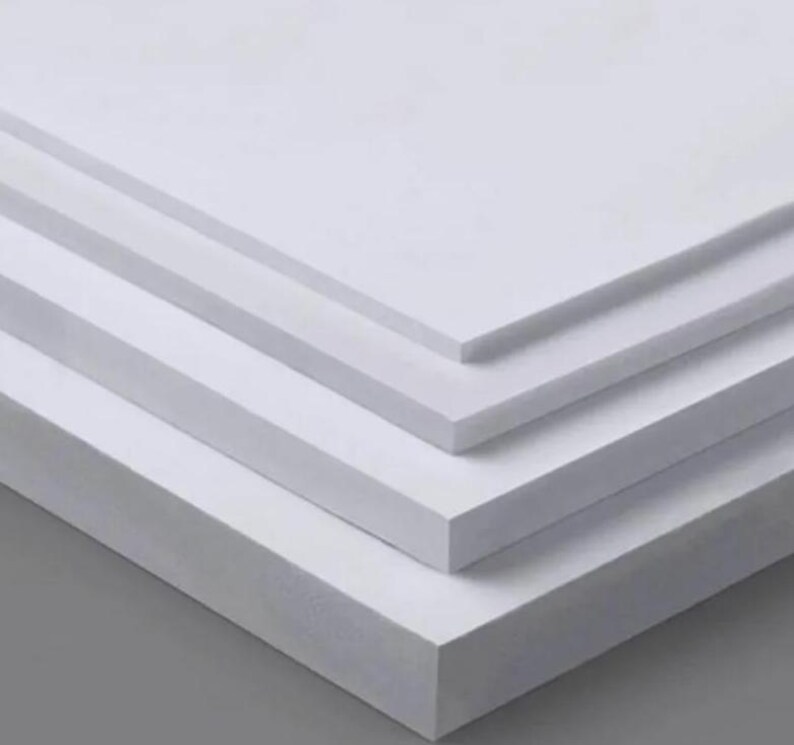 May include: Stack of four white foam core boards, each with a smooth, flat surface.