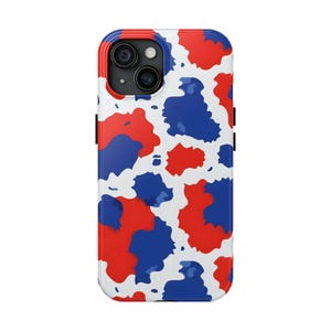 May include: A white phone case with a red and blue abstract pattern. The case has a raised camera bump with a black outline.