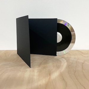 May include: A black CD jewel case with a clear CD inside. The case is open and the CD is visible.