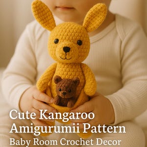 May include: A handmade, mustard yellow crochet kangaroo amigurumi with a small brown baby kangaroo in its pouch. The kangaroo has black eyes and a smiling face. The text "Cute Kangaroo Amigurumii Pattern Baby Room Crochet Decor" is at the bottom.