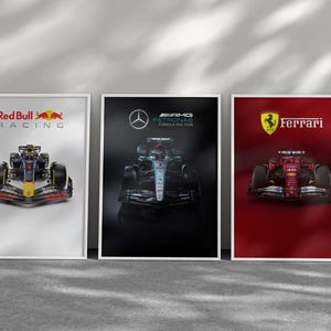 May include: Three framed posters featuring Formula 1 race cars. The first poster displays a Red Bull Racing car with the team's logo. The second poster showcases a Mercedes-AMG Petronas car. The third poster features a Ferrari car.