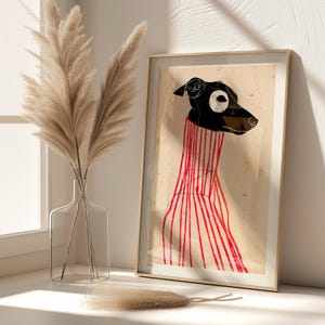 Puede incluir: Una ilustraci&oacute;n enmarcada de un perro blanco y negro con un su&eacute;ter a rayas rojas y blancas. El fondo es de color beige claro con salpicaduras rojas y blancas.