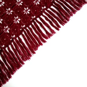 The image highlights the intricate side edge of an evening shawl.