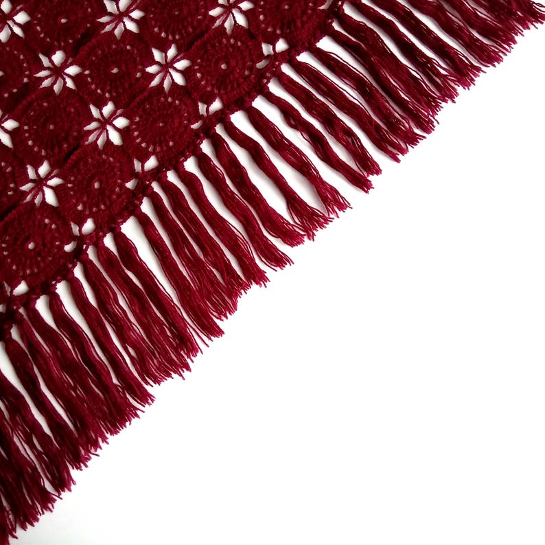 The image highlights the intricate side edge of an evening shawl.